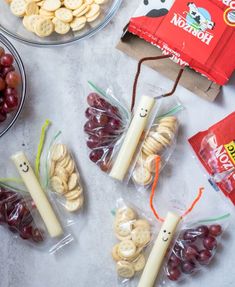 grapes, crackers, and other snacks are on the table