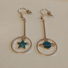 Gold, Asymmetrical Drop Earrings! One Earring Has A Iridescent Teal Saturn Charm, And The Opposite Earring Has A Same Color Star Charm! French Ear Wires With Rubber Stoppers! These Earrings Are So Whimsical And Different! Would Make A Great Gift For Anyone Interested In Astrology, Science, Astronomy, Or Just Because These Earrings Are So Unique!!! Saturn Charm, Planet Earrings, Science Astronomy, Dolphin Earrings, Cameo Earrings, Retro Earring, One Earring, Tassel Drop Earrings, Emerald Earrings