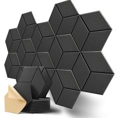 several black and white hexagonal tiles next to each other on a white surface