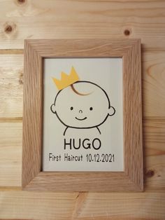 a wooden frame with a baby's name and a crown on it that says hug