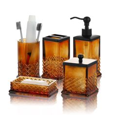 an assortment of bathroom accessories including soap dispenser, toothbrush holder and tissue dispenser