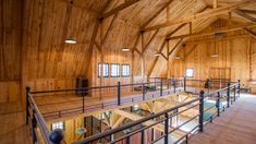 the inside of a large wooden building with metal railings