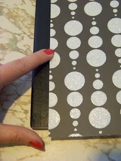 a woman's hand holding onto a piece of paper with circles on it