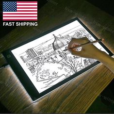 a person is drawing on an ipad with the american flag in the backgroud