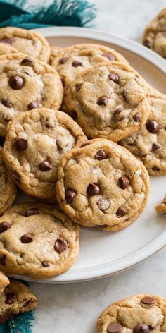 a plate full of chocolate chip cookies on a table