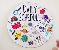 a clock with the words daily schedule painted on it's face and various school related items