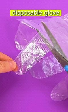 someone is holding a pair of scissors in their right hand and they are wrapped in plastic