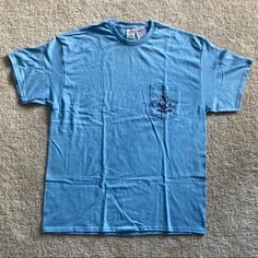 Brand New With Tags Pocket T-Shirt With Delray Beach, Florida, Anchor Design On The Pocket. 100% Cotton. Size Extra Large (Xl). I Accept Or Counter All Offers! Casual Light Blue T-shirt For Summer, Casual Summer T-shirt With Pockets, Light Blue Cotton Beach Top, Casual Short Sleeve T-shirt For Beach Season, Vacation Tops With Pockets For Beach Season, Beach Vacation Tops With Pockets, Tops With Pockets For Beach Vacation, Summer Tops With Pockets For Beach Season, Summer Graphic Tee With Pockets