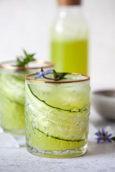 two glasses filled with cucumber and lavender water