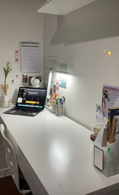 a laptop computer sitting on top of a white desk