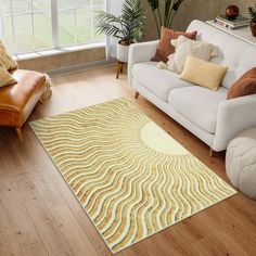 a living room filled with furniture and a large rug on top of a hard wood floor