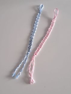 two crocheted hair ties on a white surface