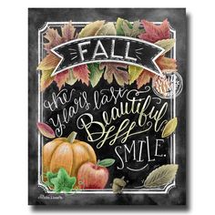 a chalkboard sign with autumn leaves and pumpkins