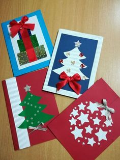 four christmas cards with bows on them and one is made out of folded paper, the other has an origami tree