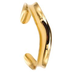 Wave cuff bangle designed by Angela Cummings for Tiffany & Co. Very Rare sculptural bangle cuff created by Angela Cummings for the Tiffany Studios in New York, back in the 1980. It was carefully crafted in a single solid piece of 18 karats yellow gold, with high polished surfaces. The design was conceived using a single semi curved and wavy element. Weight: 25.2 grams (16.15 Dwt.) Size: Fit a wrist up to 6.25 inches (16 Cm). The cuff is open so the size can be adjusted a little up or down. Measu Tiffany Studios, Vintage Cuff Bracelet, Fishing Bracelet, Gold For Sale, Elsa Peretti, Bangle Designs, Tiffany And Co, Jewelry Business, Cuff Bangles