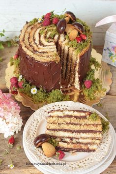 a cake with chocolate frosting and strawberries on the top is cut into pieces