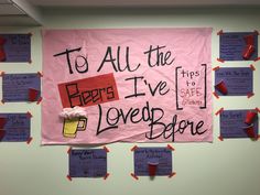 a pink sign hanging on the side of a wall next to cut up pieces of paper