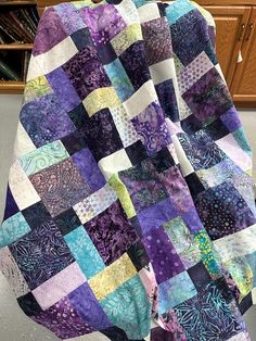 a purple and blue quilt sitting on top of a table