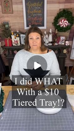 a woman sitting at a table in front of a christmas tree with the words i did what with a $ 10 tiered tray?