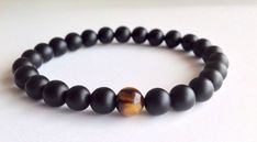 "Mens Matte Black Onyx & Tiger Eye Bracelet, Mens Beaded Bracelet, Stretch Bracelet, You are looking at a fabulous men's high quality bracelet The bracelet looks edgy with any outfit, you can combine different bracelets together or wear it with your watch. This is a beautiful and fashionable handmade bracelet, great for both Men and Women. It looks great on its own but can also be combined with different bracelets for a layered look. Tiger's Eye is a Stone of business, active people who stri Black Wristband With 8mm Beads, Inspiration Bracelets, Mens Luxury Lifestyle, Eye Bracelets, Bracelet Mens, Men Wear, Tiger Eye Bracelet, Onyx Bracelet, Men's Bracelet