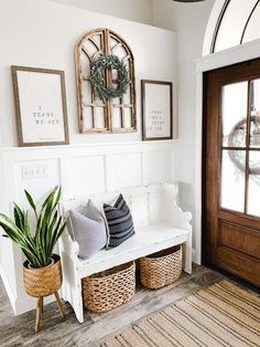 a white bench sitting next to a wooden door with two baskets on top of it