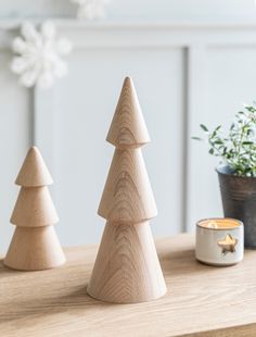 three wooden christmas trees sitting on top of a table