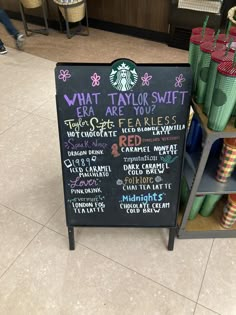 a sign that is on the ground in front of some cups and food items at a store