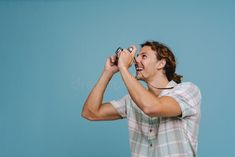 Ginger european man smiling while taking photo on retro camera royalty free stock images Man Smiling, European Men, Smiling Man, Retro Camera, Blue Background, Blue Backgrounds, Ginger