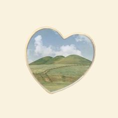 a heart shaped frame with a landscape in the middle