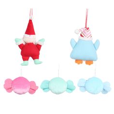 three christmas ornaments hanging from strings with hats on them, one in the shape of a fish