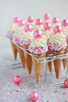 some ice cream cones with pink sprinkles on them