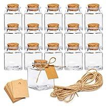 there are many glass jars with corks and tags on the top one is empty