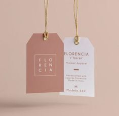 two tags hanging from strings on a pink and white background with the words florencia printed on them