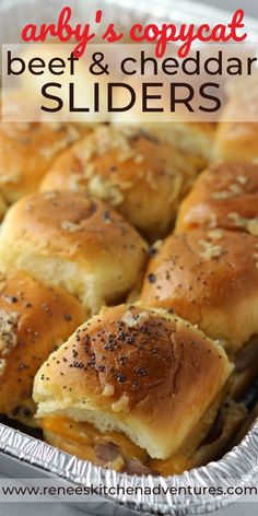 a close up of some sliders in a pan with cheese and black sesame seeds