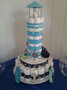 a cake made to look like a tower with lots of diapers on it and an umbrella