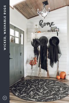 the entryway is decorated for halloween with black and white decor, pumpkins and decorations