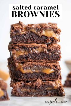 a stack of brownies with caramel drizzled on top, stacked next to each other