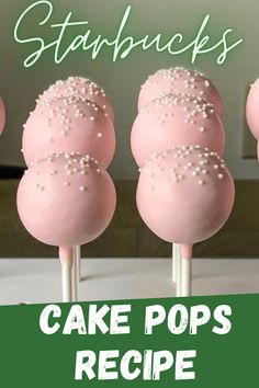 pink cake pops with white sprinkles are on a green and white table