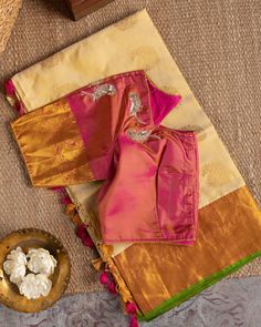 "Color : Natural Silk color and Pink. Kanchipuram silk saree in beige, flanked by golden brocade work on pink borders and pallu, paired with a pink blouse flaunting golden brocade on the sleeves and adorned with sequin-embroidered peacocks. This saree is for sure to look even more stunning when worn for any occasion.  This saree is very easy to drape and falls elegantly making it so effortless to carry around. *Fall, Pico & Tassels : Done *Condition : New Saree With Stitched Blouse with Maggam w Wedding Handloom Tissue Silk Blouse, Gold Tussar Silk Blouse With Traditional Drape, Gold Tussar Silk Blouse With Zari Work, Gold Tussar Silk Blouse For Festivals, Gold Tussar Silk Set With Unstitched Blouse, Tissue Silk Blouse With Traditional Drape For Puja, Festive Gold Tussar Silk Blouse, Gold Tissue Silk Blouse With Zari Weaving, Gold Chanderi Blouse For Transitional Seasons