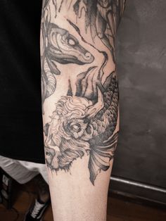 a man with a dragon tattoo on his arm