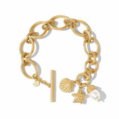 A starfish, a scallop, and an oval pearl charm dangle together from the final link of this bracelet composed of alternating ridged golden ovals. 24K gold plate, shell pearl Length: 7.25 / 8 inches (adjustable) Width: 1.4 inches Closes with toggle Julie Vos hallmark Picture Frame Ornaments, Derby Fascinator, Julie Vos, Gold Link Bracelet, Sun With Sunglasses, Clover Earrings, Holiday Earring, Jewelry Card, Pearl Charms