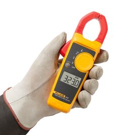 a person holding a multimeter in their right hand and measuring it with the other hand