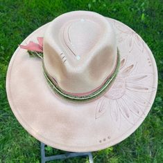 Discover the rugged charm of our Burned Western Hat. This unique, handcrafted cowboy hat features a distressed look, giving it a vintage, well-worn appeal perfect for Western enthusiasts and fashion-forward individuals. Features: Handcrafted Design: Each hat is meticulously burned and distressed to achieve a one-of-a-kind look. Premium Materials: Made from high-quality materials for durability and comfort. Unique Aesthetic: The burned finish adds a distinctive vintage style that sets it apart. Benefits: Custom and Unique: No two hats are exactly alike due to the handcrafted burning process. Versatile Style: Ideal for Western-themed events, country outings, or adding a rugged touch to everyday outfits. Durable Construction: Designed to withstand wear and tear while maintaining its unique ap Artisan Felt Hat For Summer Rodeo, Handmade Brimmed Hat For Ranch, Handmade Brimmed Fedora For Ranch, Rustic Hat For Kentucky Derby And Country Events, Rustic Hats For Country Events And Kentucky Derby, Rustic Fedora For Kentucky Derby And Country Events, Rustic Wide Brim Fedora For Kentucky Derby, Handmade Wide Brim Fedora For Ranch, Handmade Country Style Fedora For Western-themed Events