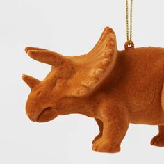 an ornament shaped like a rhinoceros is hanging from a gold chain