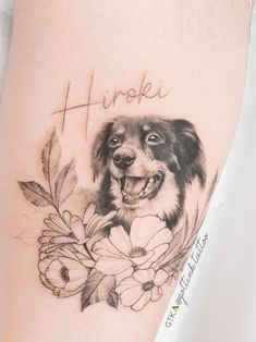 a black and white photo of a dog with flowers on it's leg that says happi