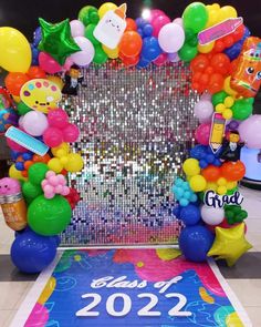 an arch with balloons and confetti for a new year's eve celebration