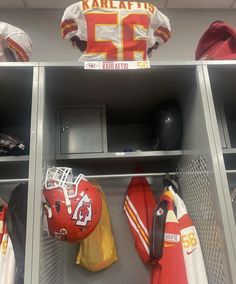 football uniforms and helmets are on display in the locker room