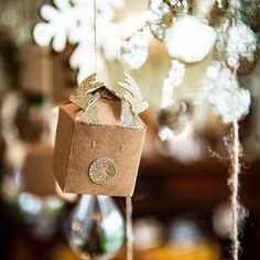 a brown box hanging from a tree with snowflakes on the top and bottom