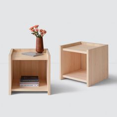 two small wooden tables with flowers on top and books in the bottom, both side by side