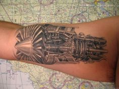 a man's arm with a tattoo on it that has an engine and gears